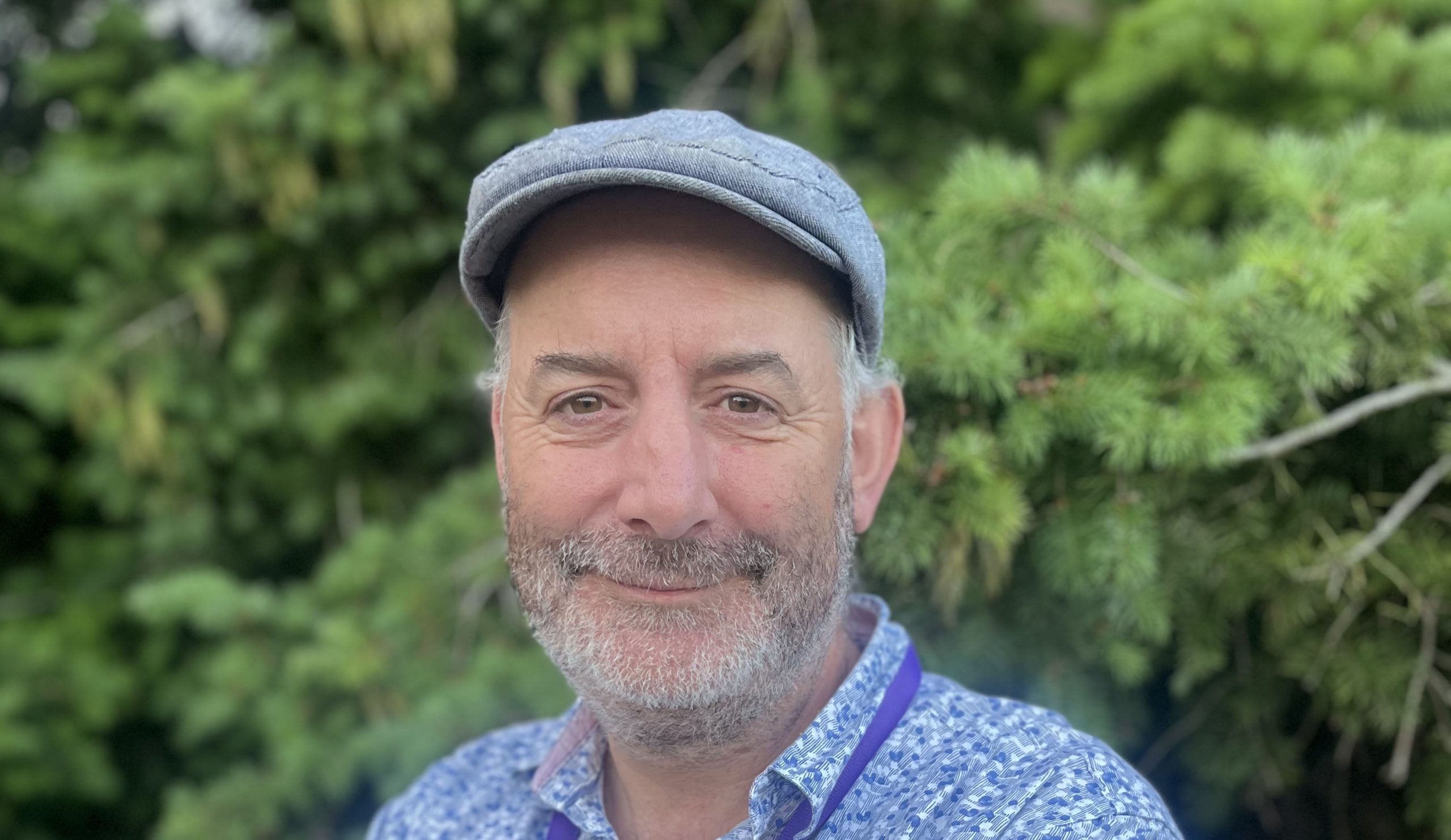 Matthew Linley - a man in cap looks at camera