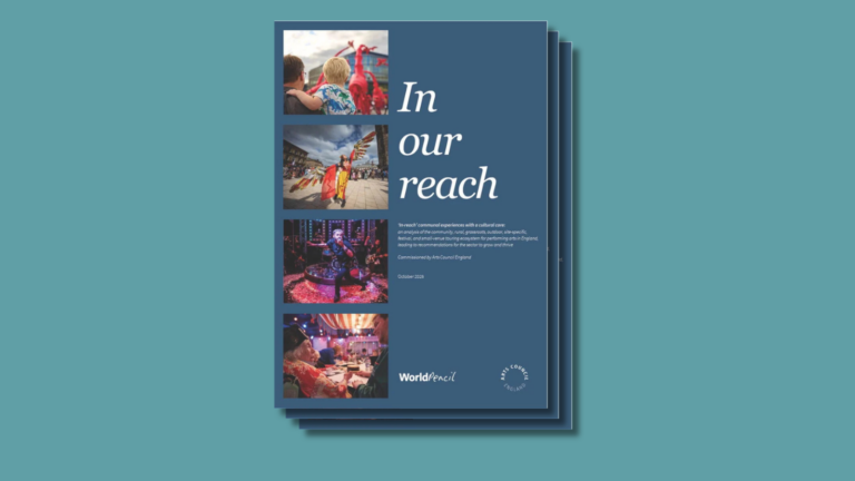 A stack of dark blue report booklets against a teal background. The cover features the title In our reach in large white lettering, alongside four photographs of arts performances and community gatherings. The October 2026 report includes World Pencil and Arts Council England logos.